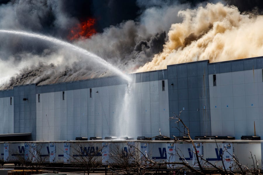 A massive fire burns inside a Walmart distribution center in Plainfield, Ind., near the Indianapolis International Airport Wednesday, March 16, 2022.