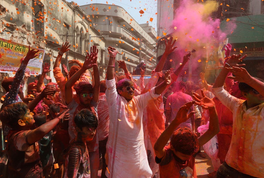 People celebrate Holi, the Hindu festival of colors, in Hyderabad, India, Thursday, March 17, 2022. Holi also heralds the arrival of spring. (AP Photo/Mahesh Kumar A.) ORG XMIT: HYD107