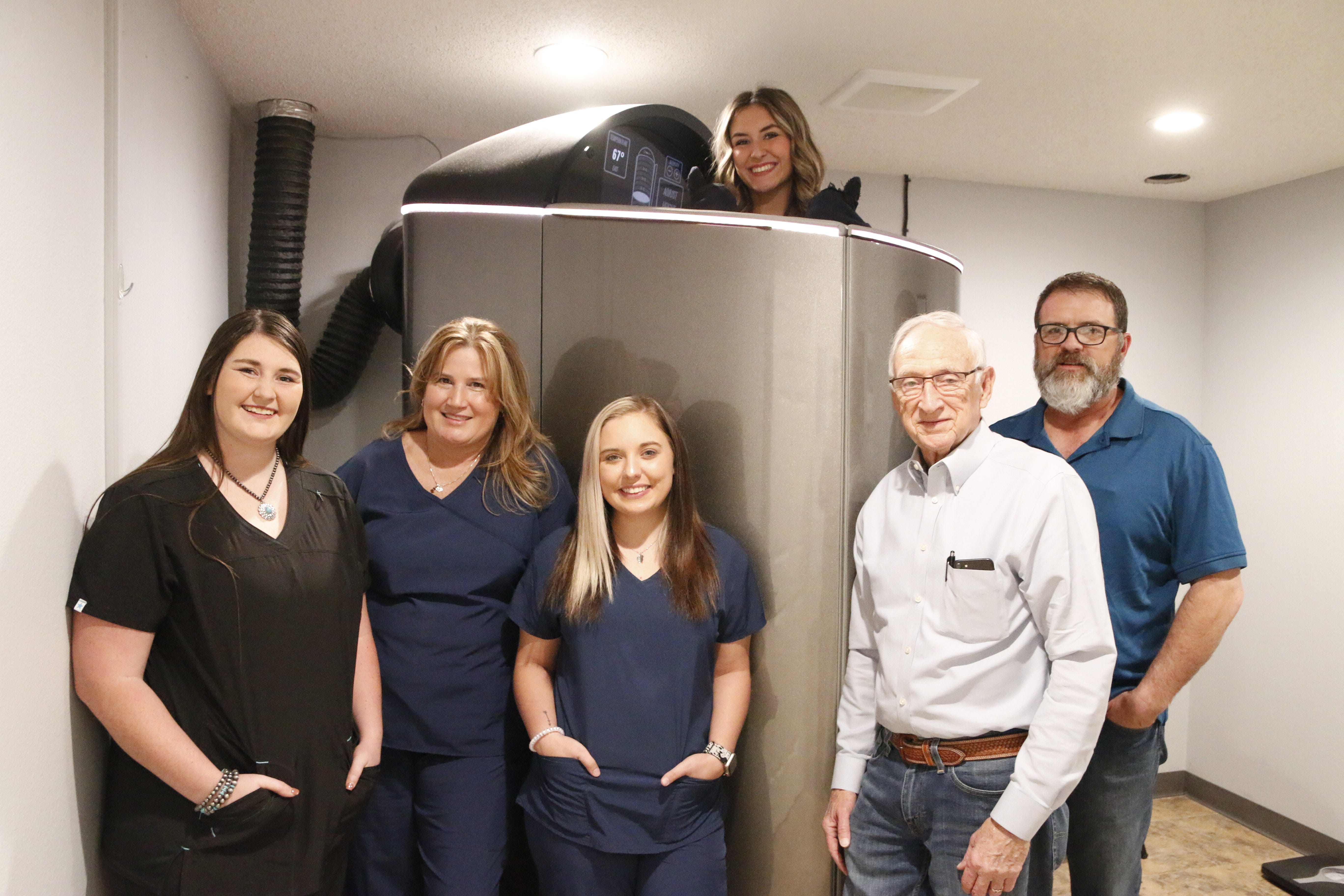 Innovation Wellness owners Bill and Scott King are pictured with staff members as they demonstrate the cyrotherapy machine. From left are Aspen Williams, Kim Atkinson, Makina Lawdermilk, Tori Wheeler, Bill King and Scott King.