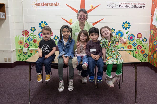Maryjo Flamm-Miller poses with several of the kids that come to the Discovery Garden. Flamm-Miller has been part of the program since 2006. 