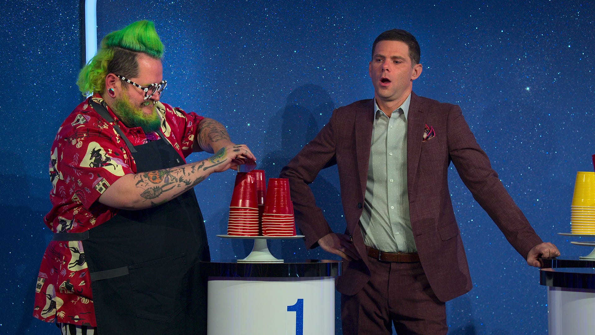 Andrew Fuller reveals his cake alongside host Mikey Day in episode 5 of "Is It Cake?"