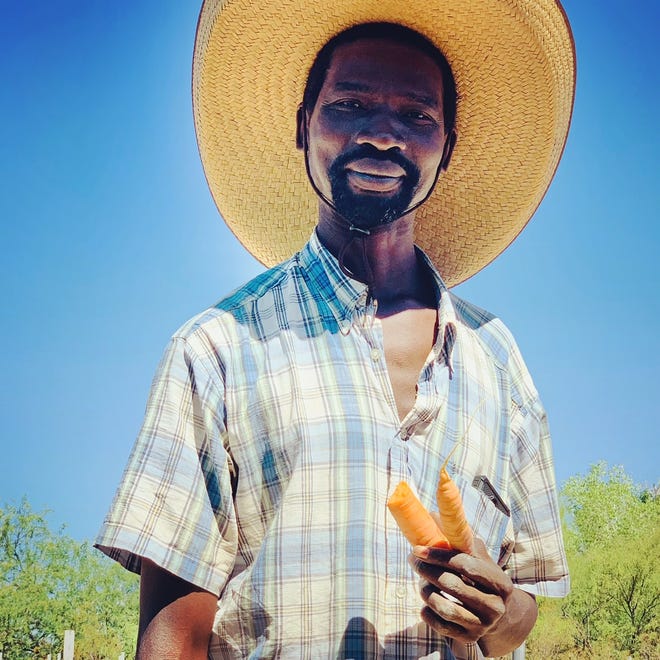 Mathurin Maoundonodji, pictured here at an Iskashitaa harvest in May 2021, has cultivated a life of service in Tucson. Before he was granted resettlement fourteen years ago, he spent six years in a refugee camp in Benin after fleeing political violence in his home country of Chad.