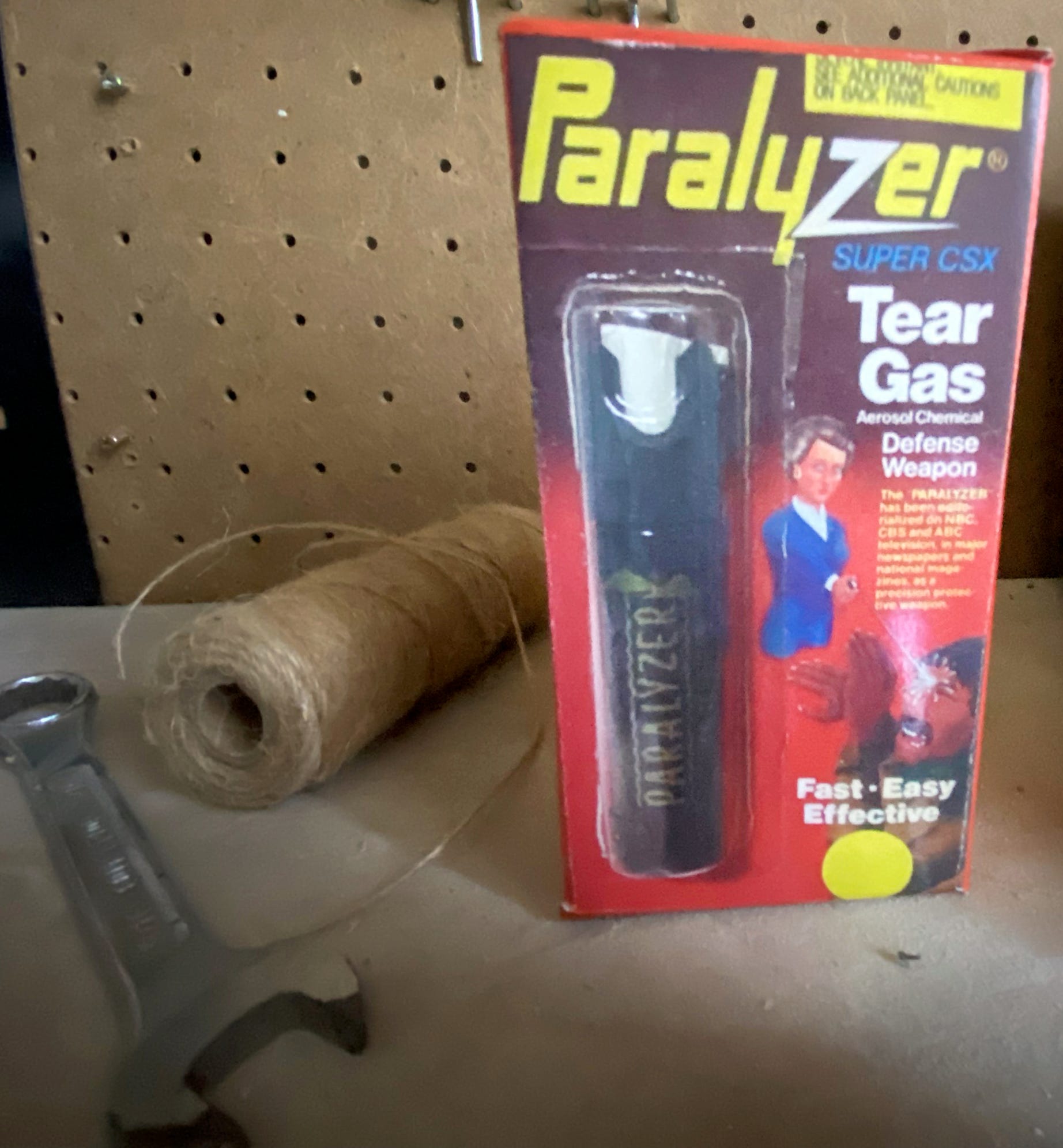 Packaging illustration for Paralyzer tear gas showed a white female in business attire defending herself against a dark-skinned man.