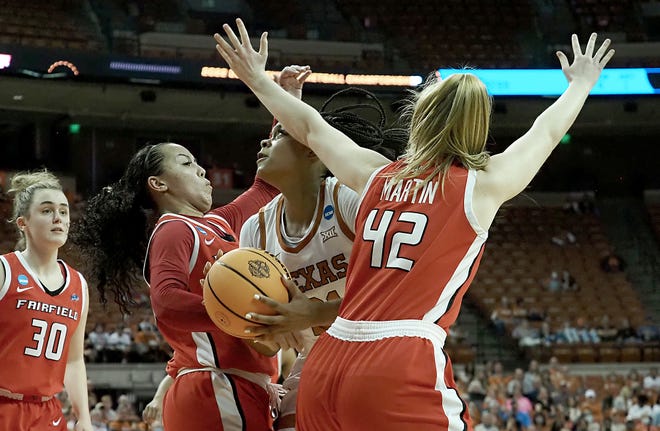 Texas' Aaliyah Moore goes between Fairfield defenders Callie Cavanaugh and Mackenzie Martin during the Longhorns' 70-52 win in the first round of the NCAA Tournament at the Erwin Center. Moore finished with 18 points and 10 rebounds.