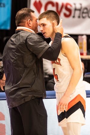 Waverly Tigers boys basketball coach Travis Robertson hugs his son senior Trey Robertson after a final four 58-43 loss against Gilmour Academy  at the University of Dayton Arena in Dayton, Ohio, on March 16, 2022.