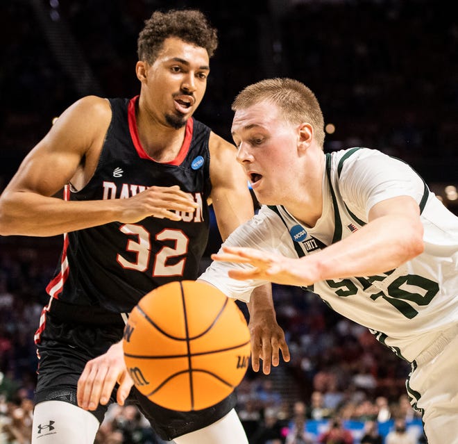 Michigan State's forward Joey Hauser (10) attempts to dribble around Davidson's forward Nelson Boachie-Yiadom (32) during the NCAA Div. 1 Men's Basketball Tournament first-round game at Bon Secours Wellness Arena in Greenville, S.C. Friday, March 18, 2022.