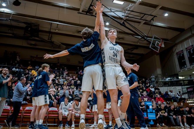 Central Catholic forward/center Albert Schwartz (34) and Central Catholic guard Alex Hardebeck (30) high-five during the introductions in the Gary 21st Century vs Lafayette Central Catholic 1A Semi-State basketball game, Saturday Mar. 19, 2022 in Lafayette.
