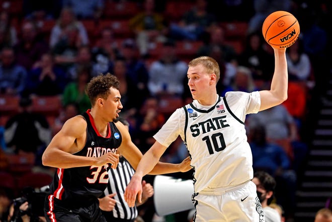 Mar 18, 2022; Greenville, SC, USA; Michigan State Spartans forward Joey Hauser (10) handles the ball against Davidson Wildcats forward Nelson Boachie-Yiadom (32) during the first round of the 2022 NCAA Tournament at Bon Secours Wellness Arena. Mandatory Credit: Bob Donnan-USA TODAY Sports