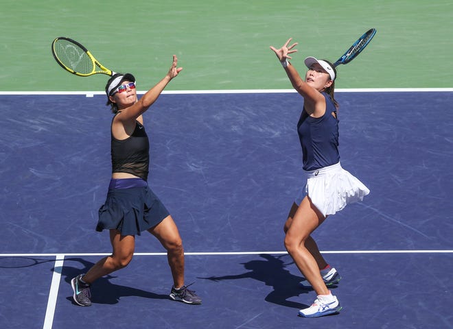 Yifan Xu, right, and Zhaoxuan Yang nearly hit the same ball during their doubles finals win at the BNP Paribas Open in Indian Wells, Calif., March 19, 2022.