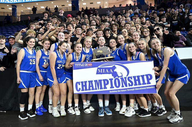 The Division 5 state champion Hopedale girls basketball team and their Blue Raiders fans pose with the trophy and banner after the 55-45 win over Hoosac Valley at the Tsongas Center in Lowell, March 20, 2022.
