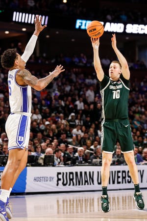 Michigan State forward Joey Hauser (10) makes a jump shot against Duke forward Paolo Banchero (5) during the first half of the second round of the NCAA tournament at the Bon Secours Wellness Arena in Greenville, SC.
