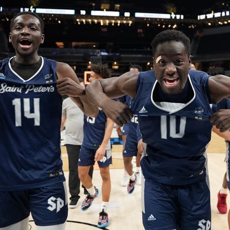 Second round: Hassan Drame (14) and Fousseyni Drame (10) celebrate after Saint Peter's upset Murray State to become the third No. 15 seed ever to reach the Sweet 16.