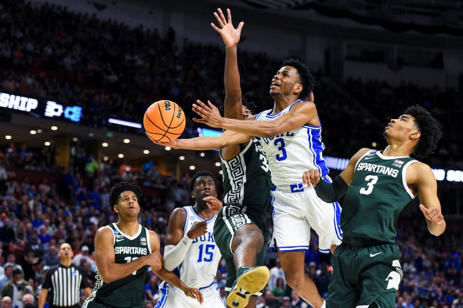 Michigan State Spartans forward Julius Marble II (34) defends as Duke Blue Devils guard Jeremy Roach (3) drives to the basket against Michigan State Spartans guard Jaden Akins (3) in the first half during the second round of the 2022 NCAA Tournament at Bon Secours Wellness Arena.