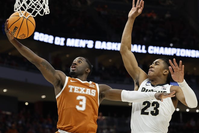 Texas guard Courtney Ramey puts up a shot as he fends off Purdue's Jaden Ivey during their second-round matchup in the NCAA Tournament. Ramey, who has been a defensive stalwart for the Longhorns the past four years, is moving on; he has entered both the NBA draft and the NCAA transfer portal.