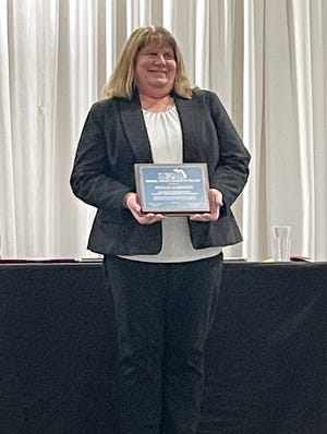 East Jordan athletic director Phyllis Olszewski is recognized Sunday by the MIAAA as the Region 2 Athletic Director of the Year in Traverse City.