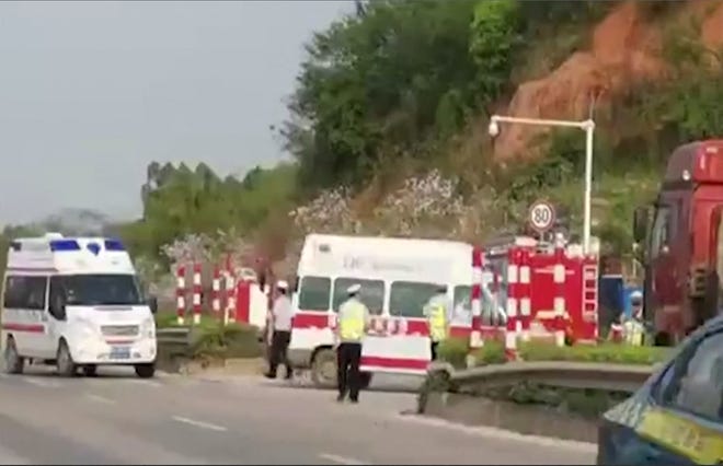 Ambulances turn off on a side road near the site of the China Eastern Airlines crash in Guangxi province on March 21.