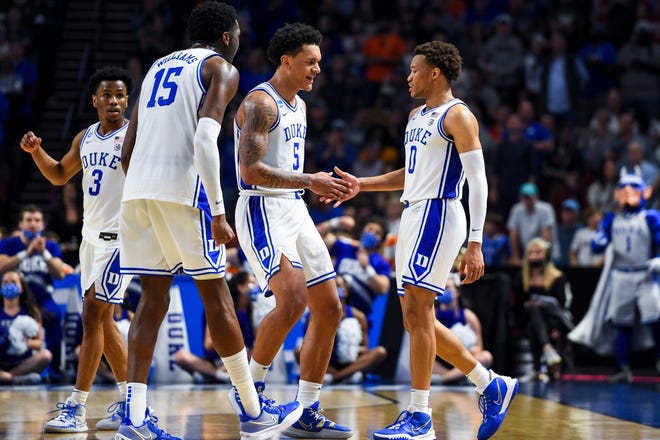Duke Blue Devils forward Paolo Banchero (5) high-fives forward Wendell Moore Jr. (0) in the game against the Michigan State Spartans in the second half during the second round of the 2022 NCAA Tournament at Bon Secours Wellness Arena.