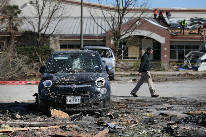 Crews clean up debris at Clay Madsen Recreation Center on March 22 after the facility was damaged by a tornado. The City Council has approved money to replace two shade structures that were damaged in the storm.
