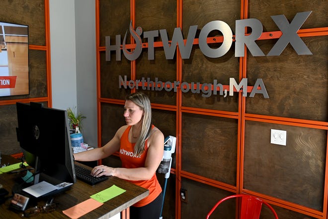 Sara Bell, co-owner of Hotworx, a new 24-hour infrared fitness studio in Northborough, works at the desk, March 22, 2022.