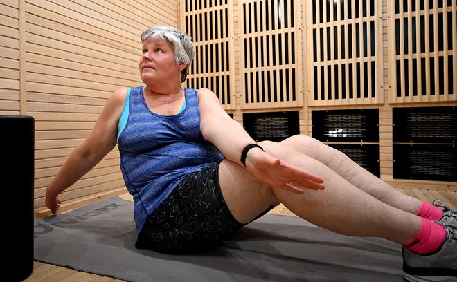 Sheryl Crowely of Berlin stretches during an infrared workout session at Hotworx,  new 24-hour infrared fitness studio in Northborough,  March 22, 2022.  A virtual instructor leads a 30-minute session in a one-person fitness room kept at 125 degrees. 