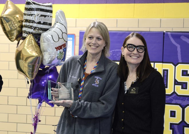 Windsor Elementary School Principal Melissa Yuska, left, poses with Jennifer Stark, Golden Apple Foundation executive director, after receiving the foundation's 2022 Outstanding Principal Award on Tuesday, March 22, 2022, at the school.