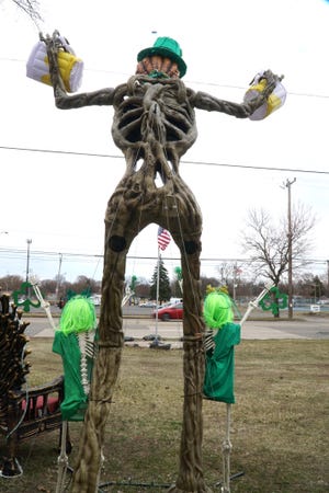                                                               A ten foot-tall St. Patty's Day themed skeleton stands outside the Beech Daly home of Donavan Richardson and his fiance Alicia Bonanno.
