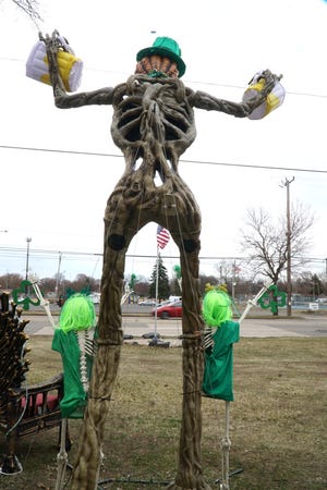 A ten foot-tall St. Patty's Day themed skeleton stands outside the Beech Daly home of Donavan Richardson and his fiance Alicia Bonanno.