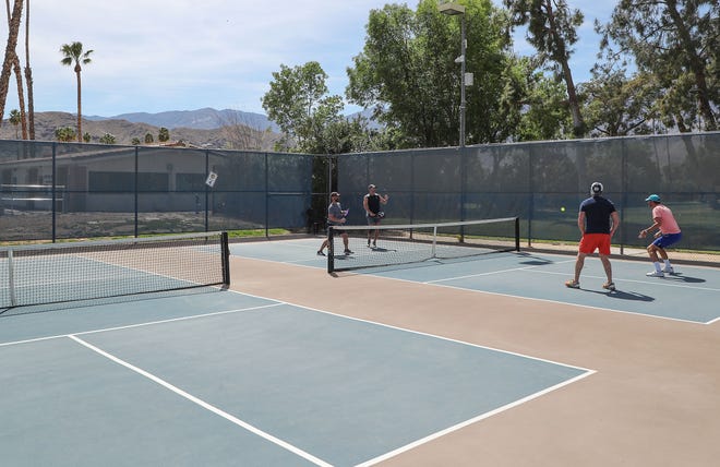 People play pickleball at Demuth Park in Palm Springs, Calif., March 22, 2022.  At left is the city's wastewater treatment plant.