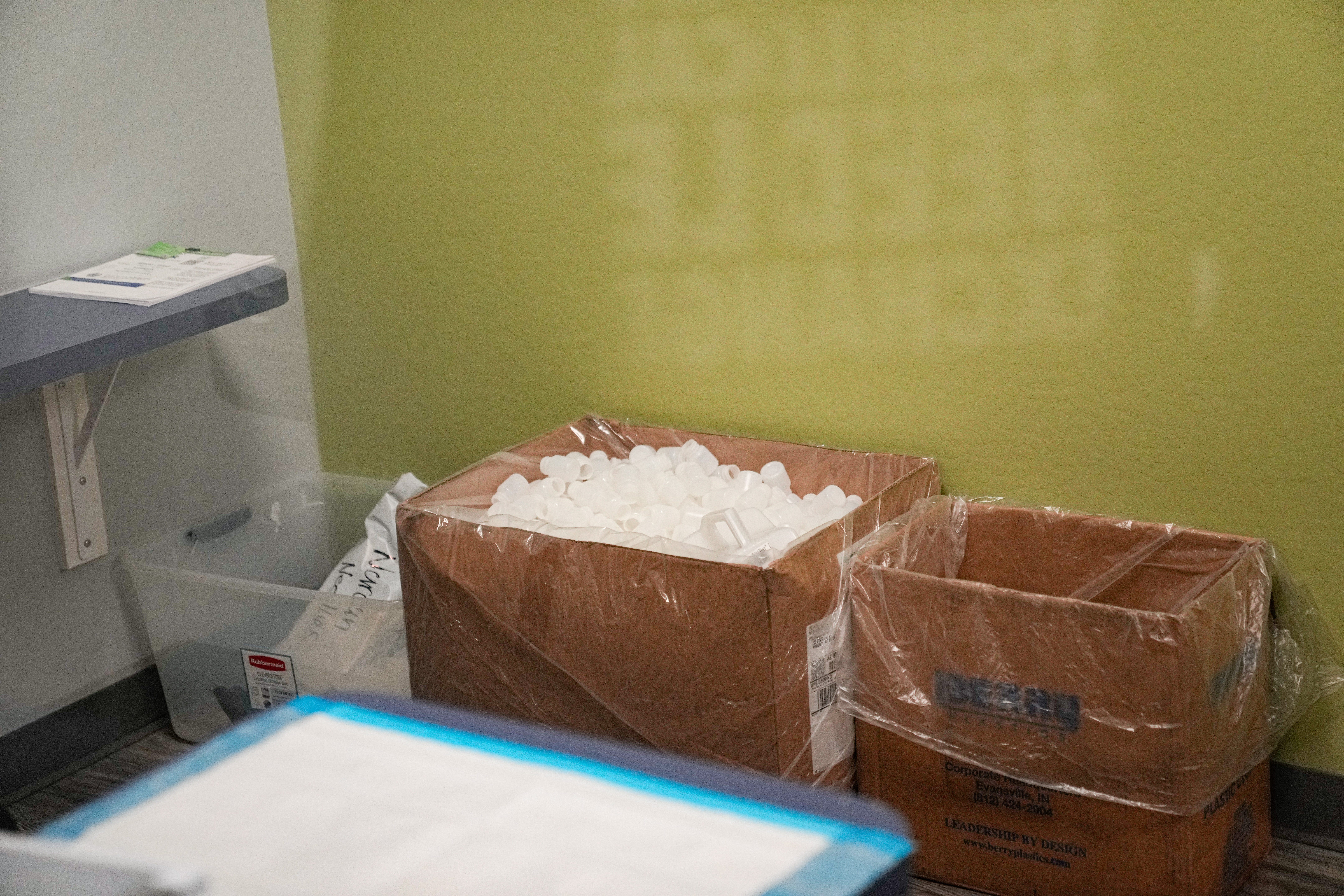 Empty plastic jars sit inside of the dosing area at Community Medical Services in Phoenix, Arizona on March 10, 2022.