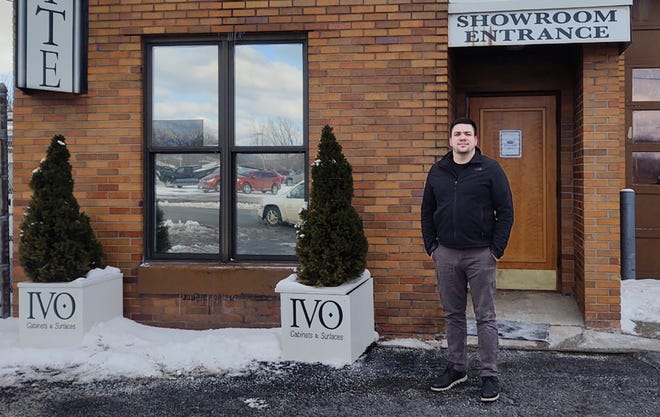 IVO Cabinets & Surfaces President & CEO Viktor Dimov poses recently in front of the Utica shop. They are giving away a brand-new kitchen and/or bath valued at up to $50,000 to give back to the community.