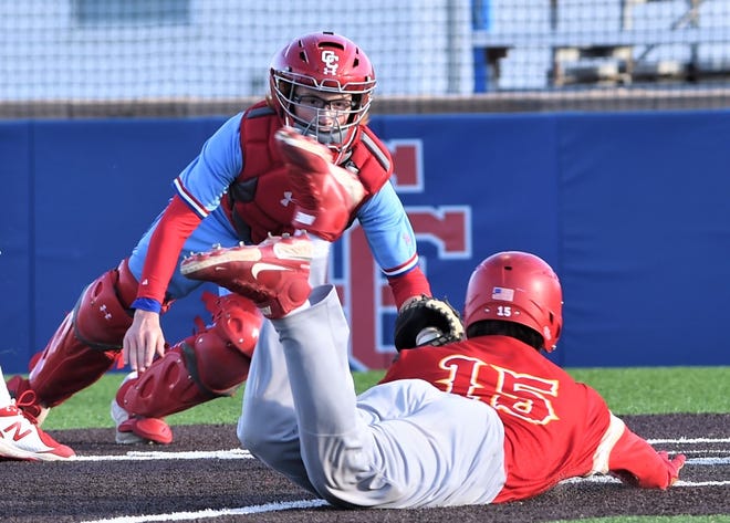 Cooper catcher Austin Cummins, left, dives toward home plate to tag out Lubbock Coronado's John Curry. Curry was trying to score from third when Kaleb Pillow reached on a wild pitch third strike in the third inning. Curry was out on the play. The Mustangs beat Cooper 6-1 in the District 4-5A game Tuesday at Cougar Field.