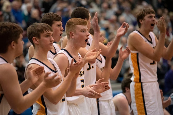 Pewamo-Westphalia varsity basketball players celebrate a point at Loy Norrix High School in Kalamazoo, Michigan on Tuesday, March 22, 2022. 