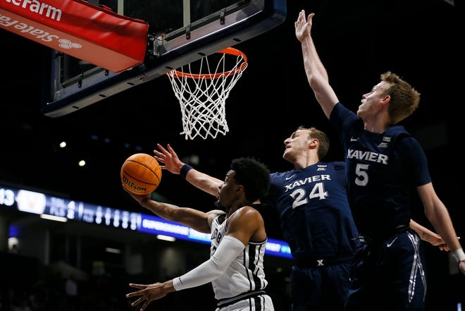 Xavier Musketeers forward Jack Nunge (24) swats away a shot by Vanderbilt Commodores guard Rodney Chatman (3) in the first half of the NIT Quarter Final game between the Xavier Musketeers and the Vanderbilt Commodores at the Cintas Center in Cincinnati on Tuesday, March 22, 2022. Vanderbilt led 31-29 at halftime. 