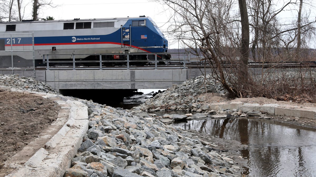 A Metro-North Railroad train passes over the rebuilt culvert north of the Dobbs Ferry Metro-North train station, March 23, 2022. 