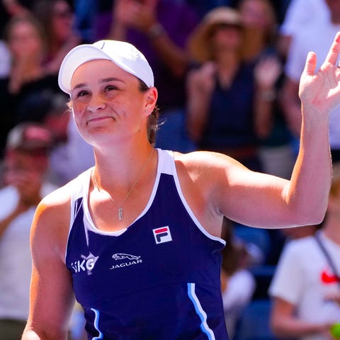 Ash Barty waves to the crowd after a win at the 20