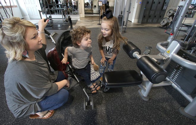 Lacy Messer and her children, 2-year-old Owen Messer and 4-year-old Sadie Messer, check out the exercise equipment at the new Cherryville YMCA on North Mountain Street Thursday afternoon, March 24, 2022.