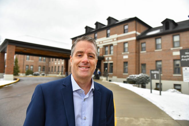 Dr. Joel Syvrud stands near the main entrance Wednesday, March 23, 2022, to the St. Cloud VA Medical Center. Syvrud was named the American LegionÕs 2021 Physician of the Year. Syvrud has worked as a podiatrist at the St. Cloud VA for 22 years.