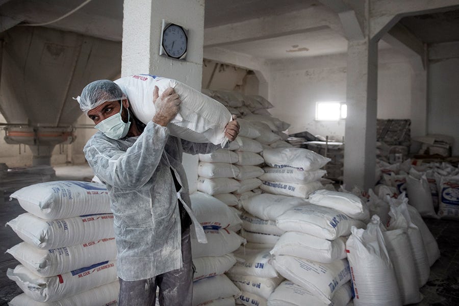 An employee carries a bag of flour at the Lermioglu flour mill in Luleburgaz, Turkey, on March 22.