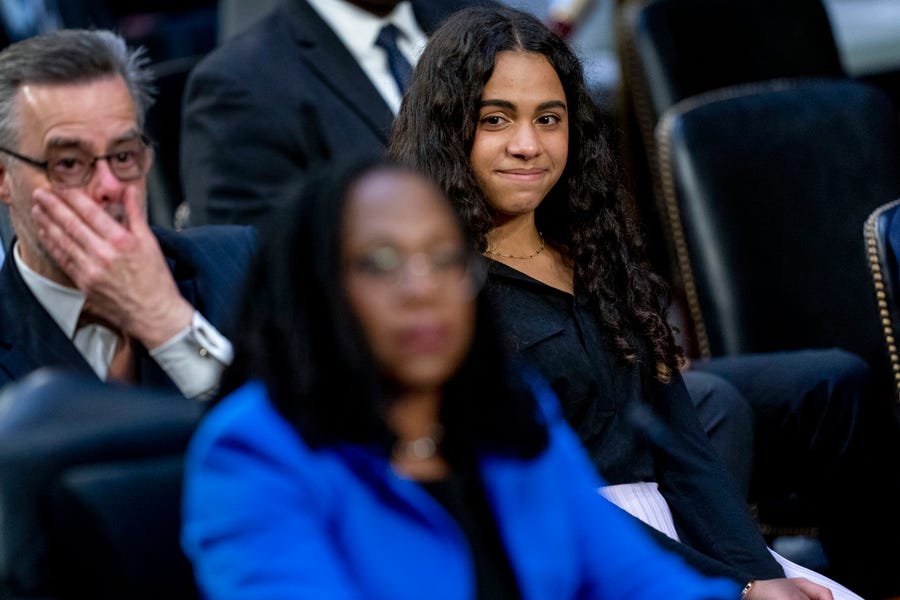 Leila Jackson, right, watches as her parents Dr. Patrick Jackson, left, and Supreme Court nominee Ketanji Brown Jackson, foreground, get emotional during a back and forth with Sen. Alex Padilla, D-Calif., during Jackson's Senate Judiciary Committee confirmation hearing on Capitol Hill in Washington, Wednesday, March 23, 2022.