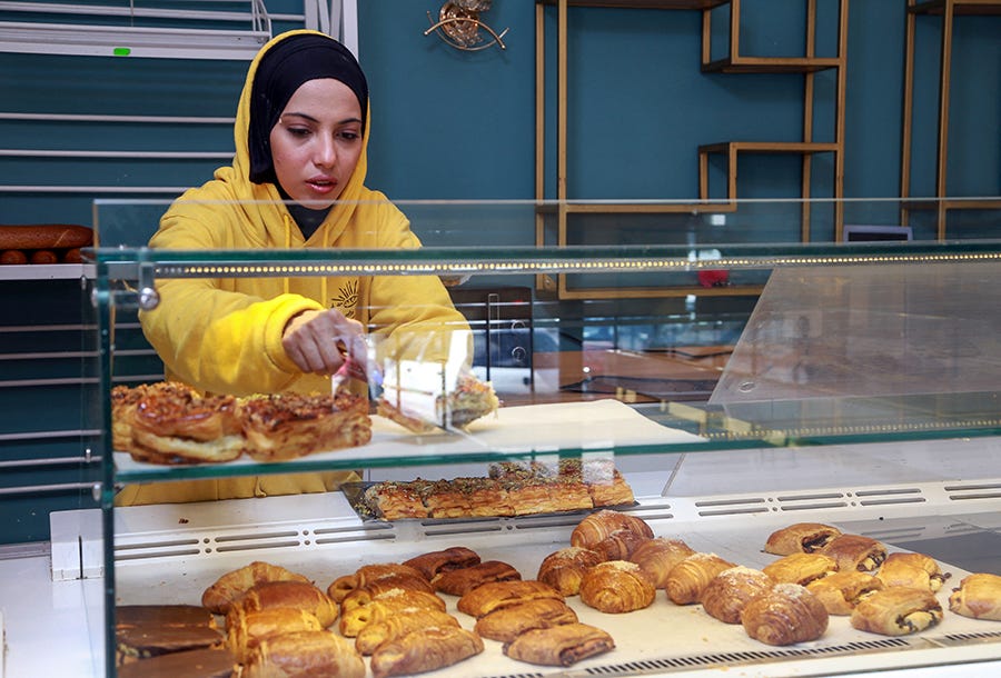 A staff member arranges baked goods at a bakery in the Tunisian capital of Tunis on March 11.