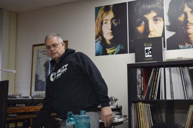 Chad Kassem, the founder and owner of Acoustic Sounds in Salina, turns on the sound system to listen to a blues record in his office. Kassem has taken his love of music and created a business with more than 100 employees that produces some of the highest quality vinyl records in the industry.