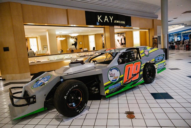 Race cars and trucks are seen on display during the annual New Towne Mall Car Show hosted by Midvale Speedway March 25 in New Philadelphia. The season opener at Midvale Speedway is set for tonight.