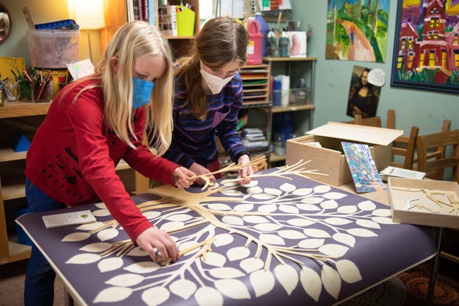 Montessori Radmoor fourth-grade students Severen Anderson, left, and Ronan Guild team up on a project Friday, March 25, 2022, in Christine Russell's upper elementary classroom.