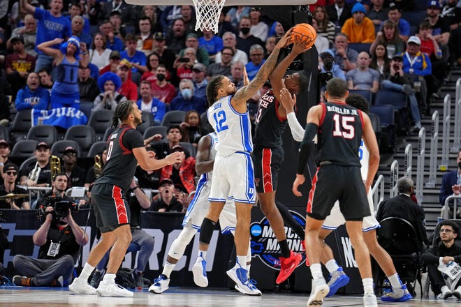 Theo John blocks the shot of Red Raiders forward Bryson Williams (11) during the second half.