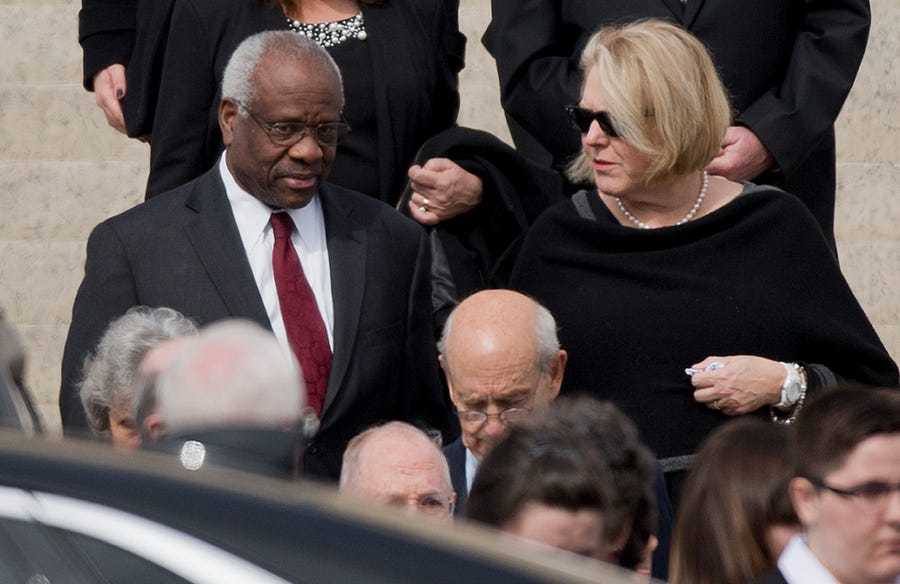 Supreme Court Associate Justice Clarence Thomas, left, and his wife Virginia Thomas, right, leave the the Basilica of the National Shrine of the Immaculate Conception in Washington after attending funeral services of the late Supreme Court Associate Justice Antonin Scalia, on Feb. 20, 2016.