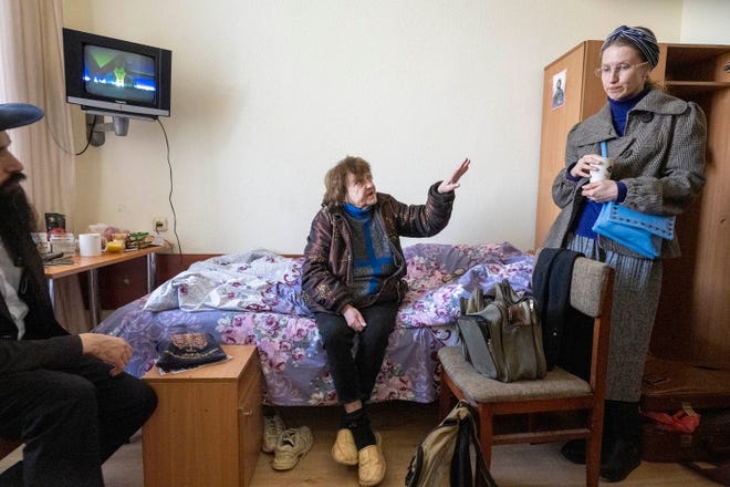 Tatiana Larina, 73, of Mykolaiv, Ukraine, tells Olena Khorenjenko, right, about her journey to a refugee housing center at Bukoria Pension in the Vodola-Veda Holiday suburb near Chisinau, Moldova, on March 24.