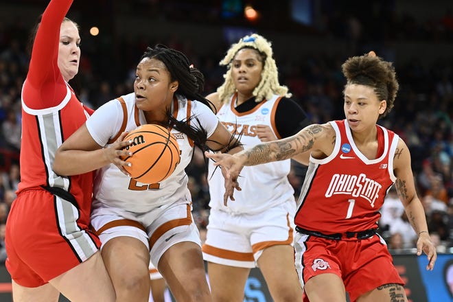 Texas forward Aaliyah Moore works for a shot against Ohio State forward Rebeka Mikulasikova, left, and guard Rikki Harris during the Longhorns' 66-63 Sweet 16 victory Friday in Spokane, Wash. Moore, a freshman, made a key block in the final minute of the game.