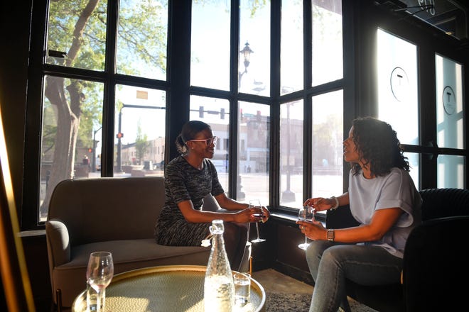 Britney Pooser (left) and Briana Williams enjoy a glass of wine at Taste Wine Room in downtown Augusta on a recent Friday.