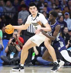 Purdue's Zach Edey (left) works against Saint Peter's Oumar Diahame in the first half in the Sweet Sixteen round of the NCAA tournament at the Wells Fargo Center in Philadelphia, March 25, 2022.