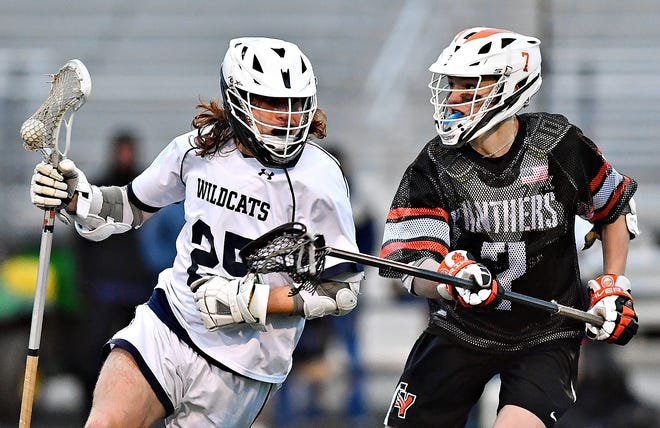 Dallastown's Colin Chapman, left, moves the ball down the field while Central York's Garrison Pate defends during boys' lacrosse action at Dallastown Area High School in York Township, Friday, March 25, 2022. Central York would win the game 11-5. Dawn J. Sagert photo